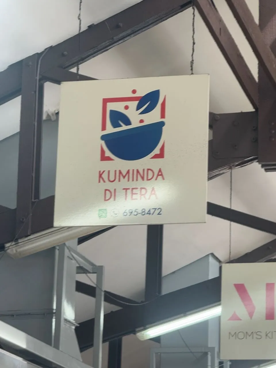 Kuminda di Tera restaurant sign in Plasa Bieu market